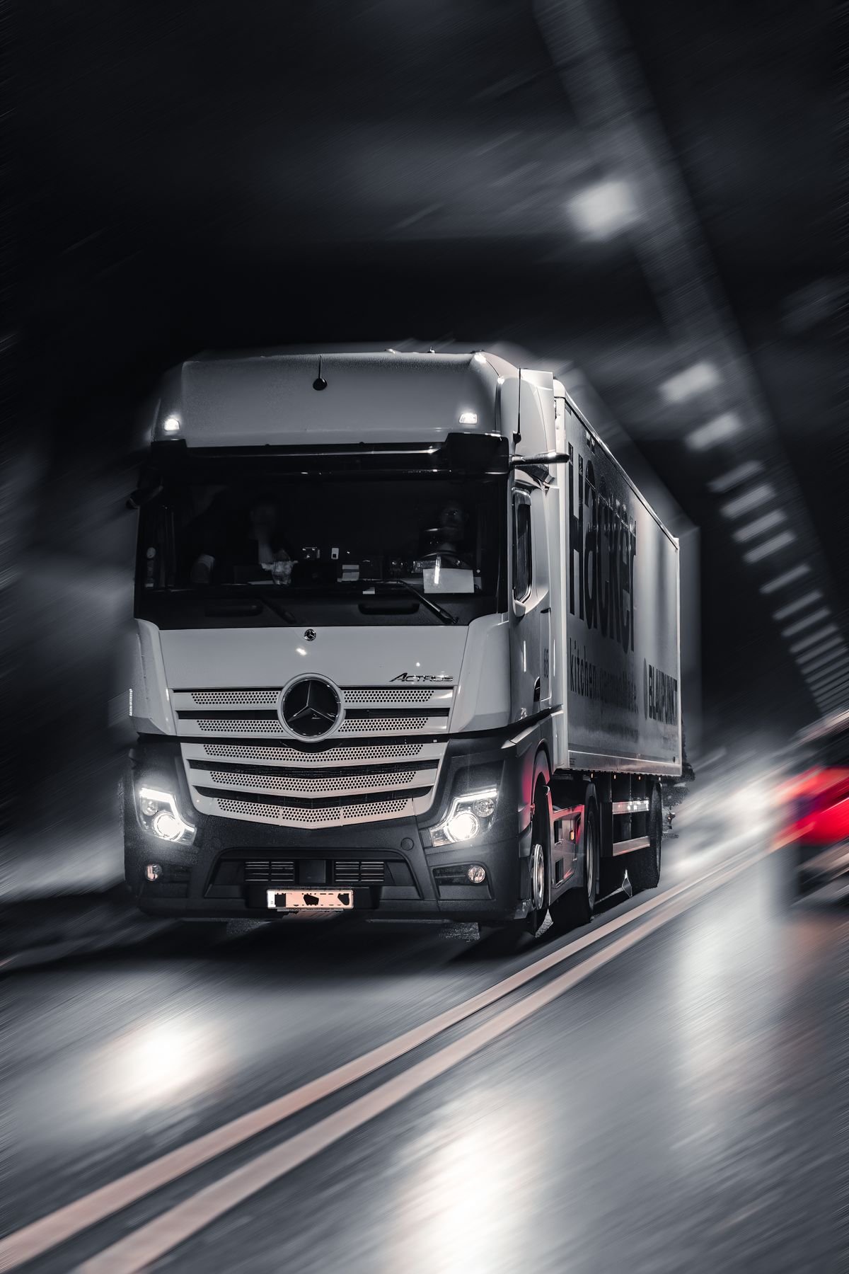 Truck in motion blur driving through a tunnel